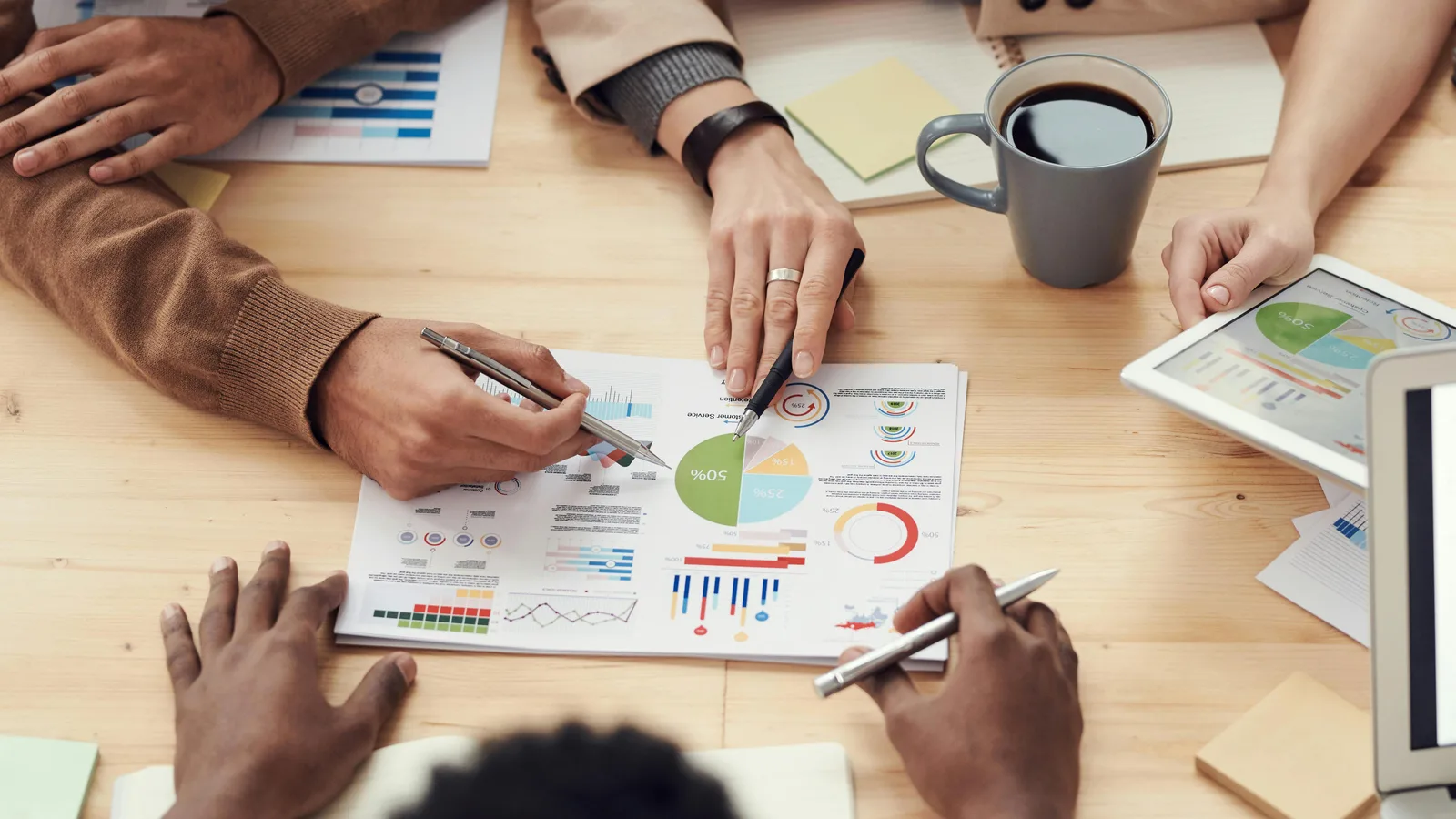 People reviewing printed business charts